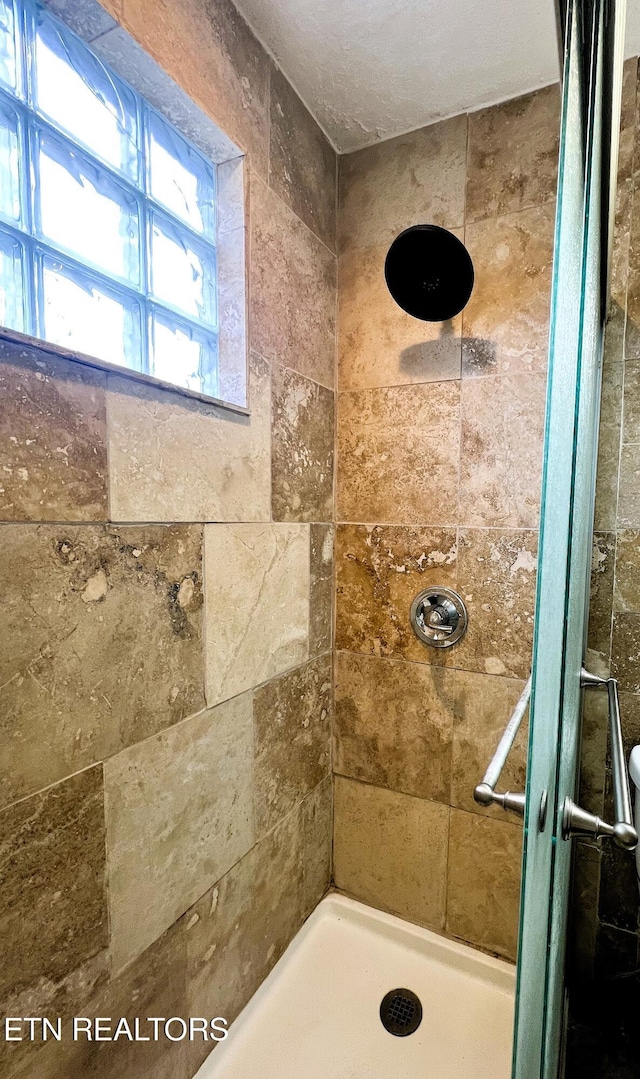 bathroom with tiled shower