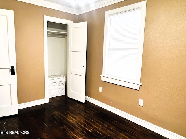 unfurnished bedroom with crown molding, dark wood-type flooring, and a closet