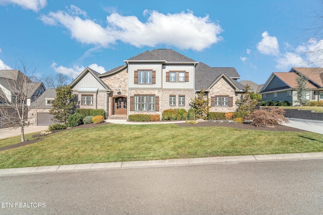 view of front of property with a front yard and stone siding