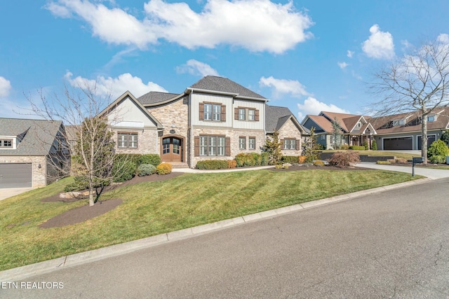 french country style house featuring stone siding, french doors, board and batten siding, and a front yard