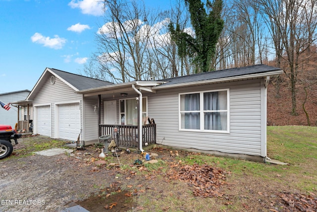 ranch-style house with a garage and a porch