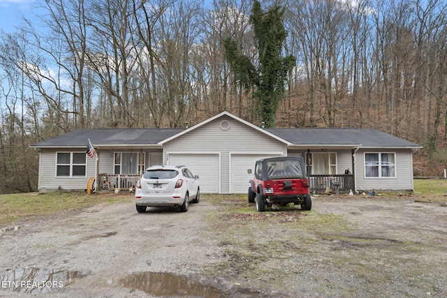 single story home with a porch and a garage