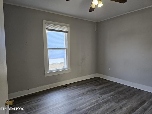 unfurnished room with crown molding, ceiling fan, and dark hardwood / wood-style flooring