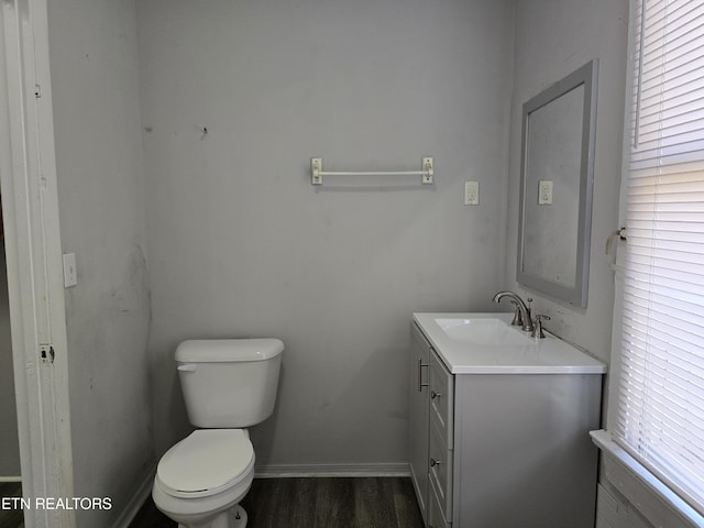 bathroom featuring hardwood / wood-style flooring, vanity, and toilet