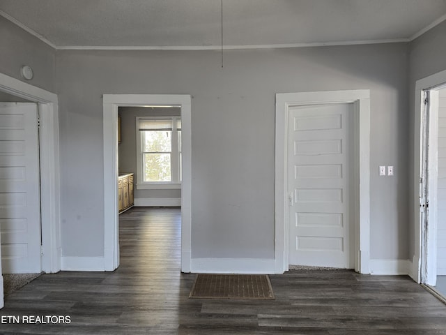 interior space featuring ornamental molding and dark hardwood / wood-style flooring