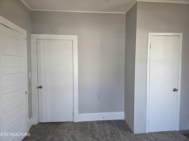 unfurnished bedroom featuring dark colored carpet and ornamental molding