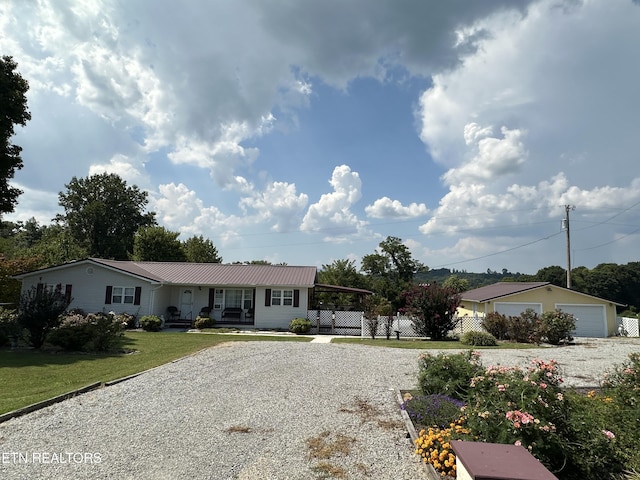 view of front facade featuring an outbuilding and a garage