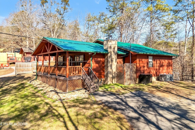 rear view of house with a porch and central AC unit