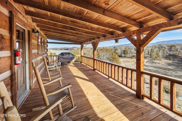 wooden terrace featuring a grill and a mountain view