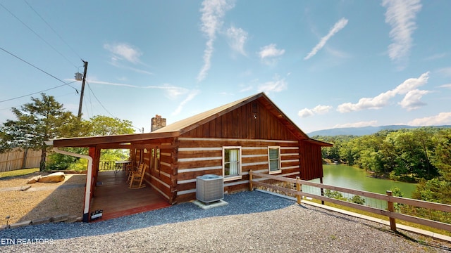 exterior space with a water view and central AC unit