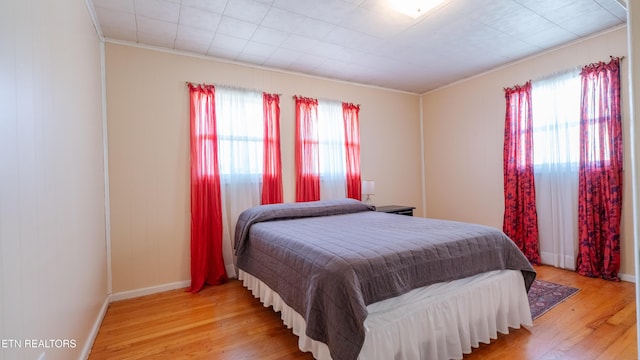 bedroom featuring multiple windows and light hardwood / wood-style floors