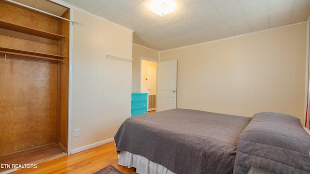 bedroom featuring crown molding and wood-type flooring