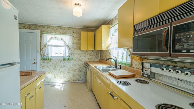 kitchen with sink and white appliances