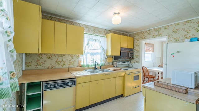 kitchen featuring dishwashing machine, sink, electric range, and white refrigerator