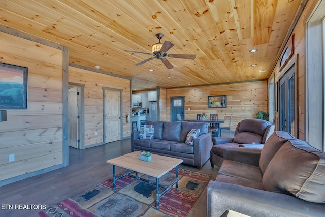 living room featuring hardwood / wood-style flooring, ceiling fan, wooden walls, and wood ceiling