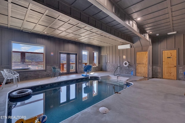 view of swimming pool with a wall unit AC and french doors