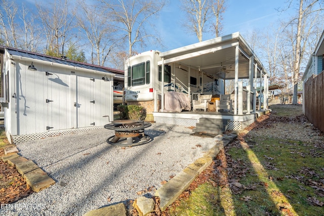 back of house featuring a storage shed