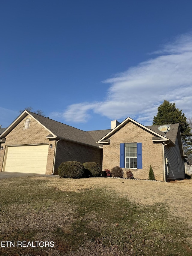 ranch-style house featuring a garage and a front yard