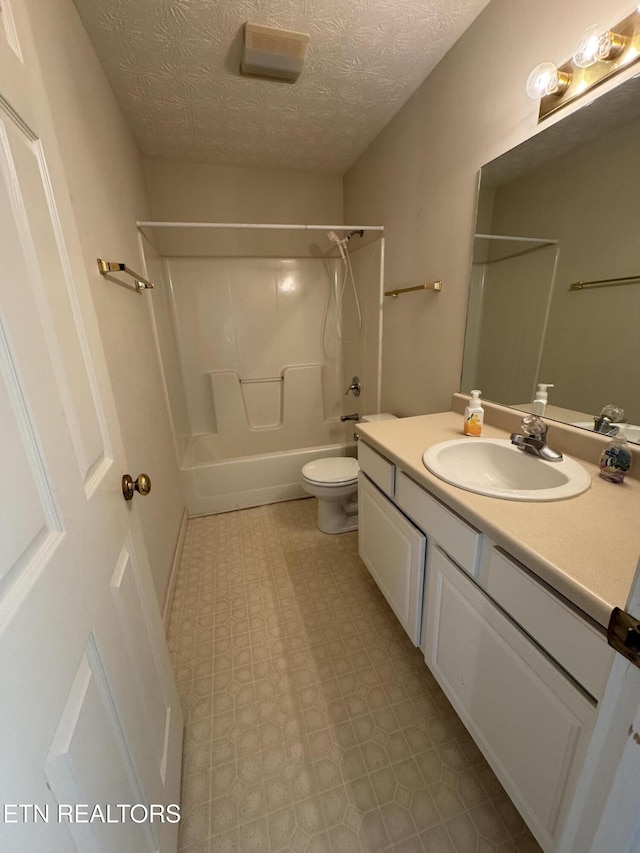 full bathroom featuring vanity, toilet, shower / bathing tub combination, and a textured ceiling