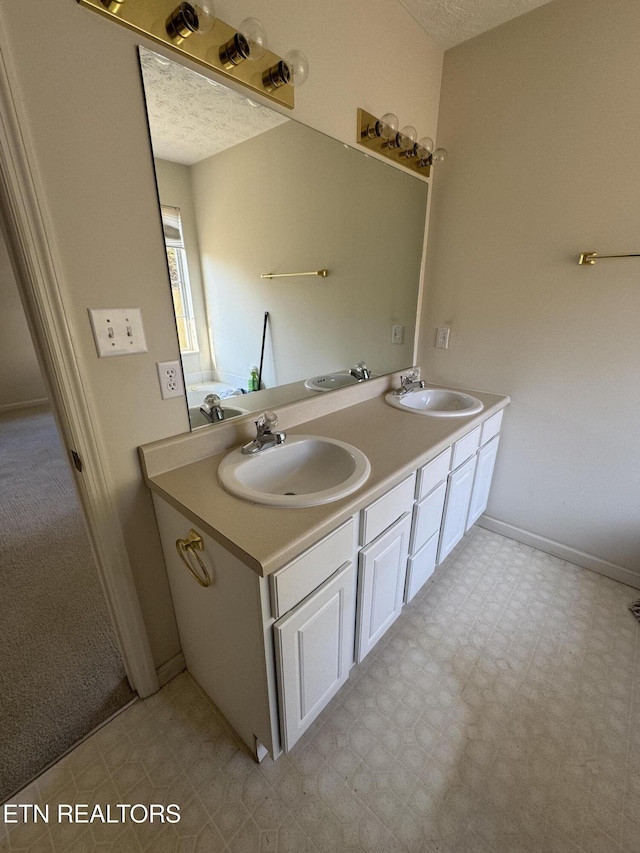 bathroom with vanity and a textured ceiling