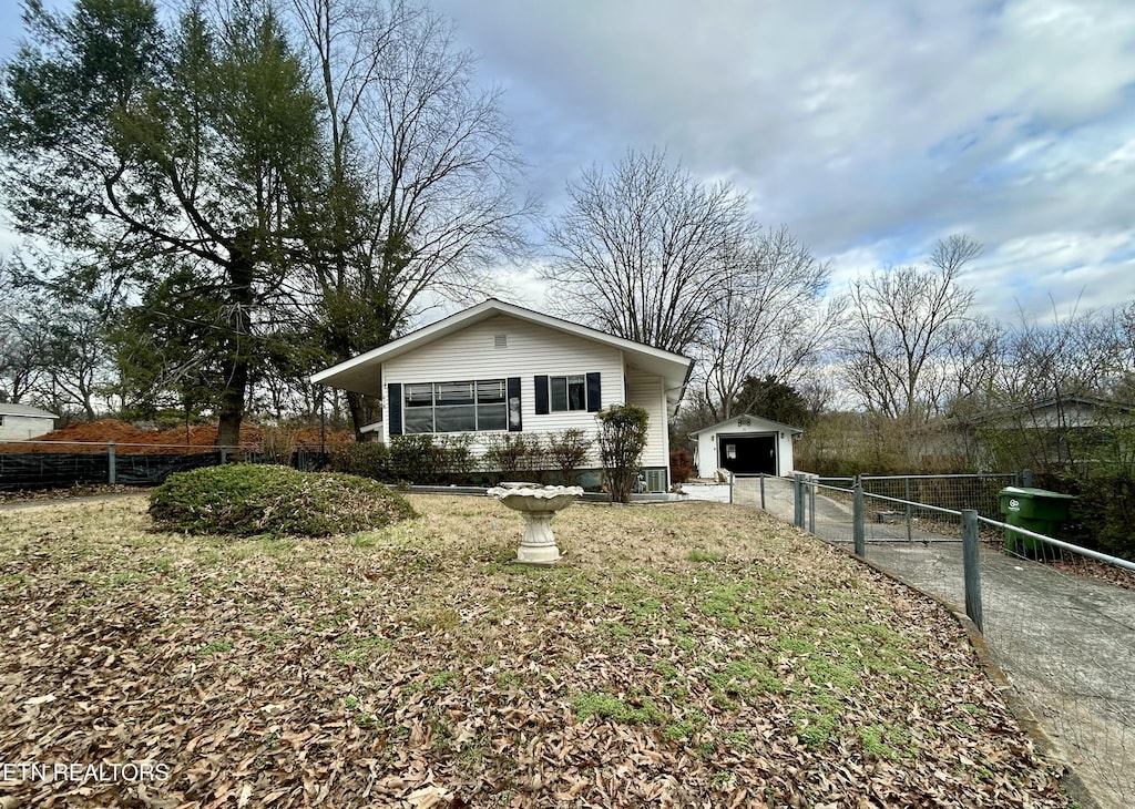 view of side of home featuring a garage and an outdoor structure