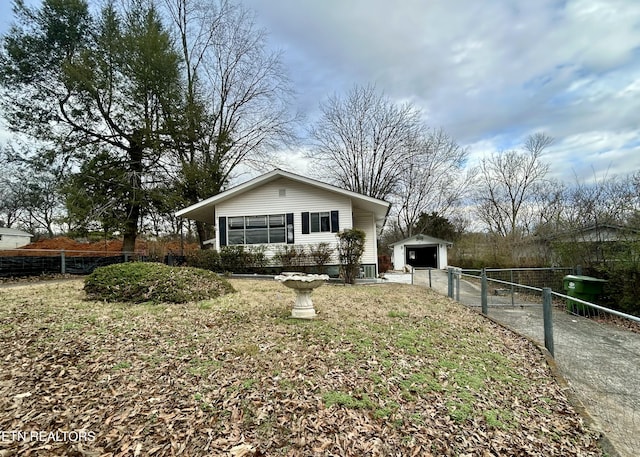 view of side of home featuring a garage and an outdoor structure