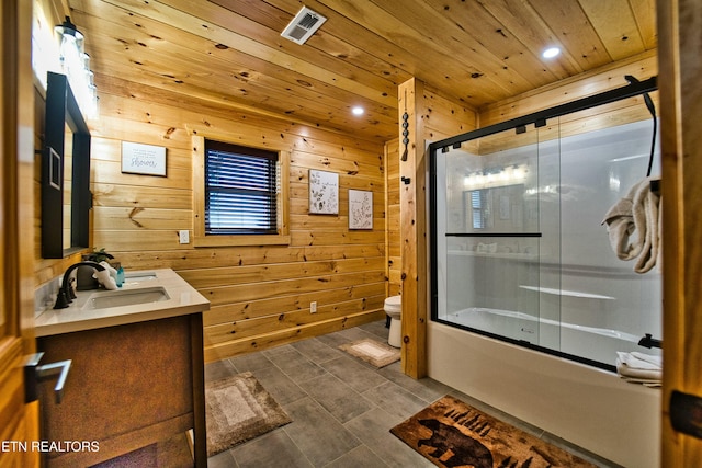 full bathroom featuring combined bath / shower with glass door, vanity, wooden ceiling, toilet, and wood walls