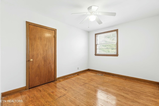 spare room featuring light hardwood / wood-style floors and ceiling fan