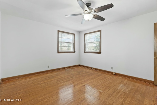 empty room featuring ceiling fan and light hardwood / wood-style floors