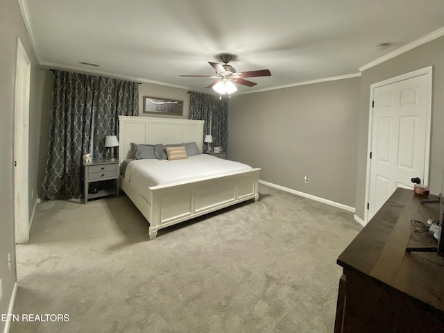 carpeted bedroom with ornamental molding and ceiling fan