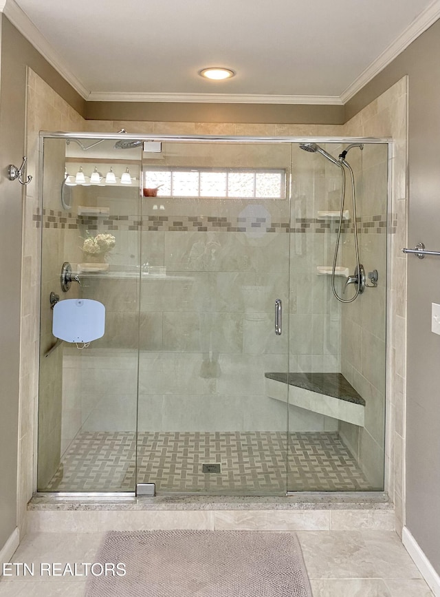 bathroom with ornamental molding and an enclosed shower