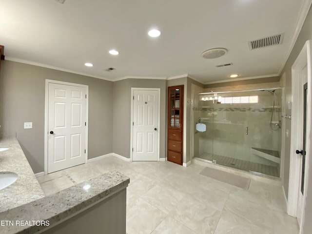 bathroom with vanity, crown molding, and a shower with door