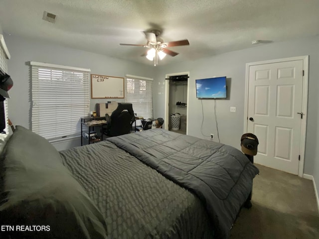 bedroom featuring ceiling fan, a closet, carpet, and a textured ceiling