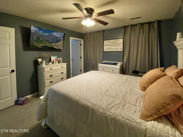 bedroom with ceiling fan, carpet flooring, visible vents, and baseboards