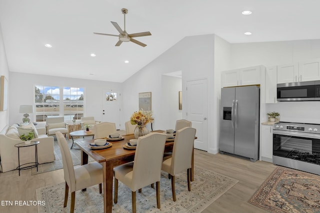 dining area featuring light hardwood / wood-style flooring, high vaulted ceiling, and ceiling fan