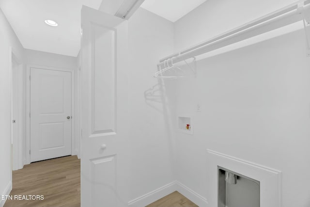 laundry room with hookup for a washing machine and light hardwood / wood-style flooring