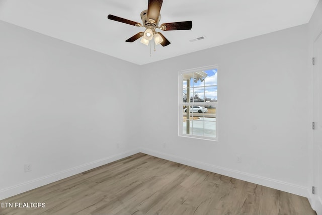 spare room with ceiling fan and light wood-type flooring