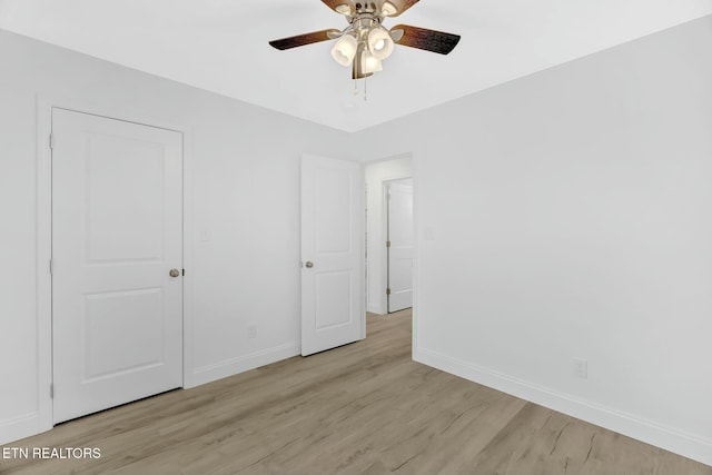 unfurnished bedroom featuring ceiling fan and light wood-type flooring