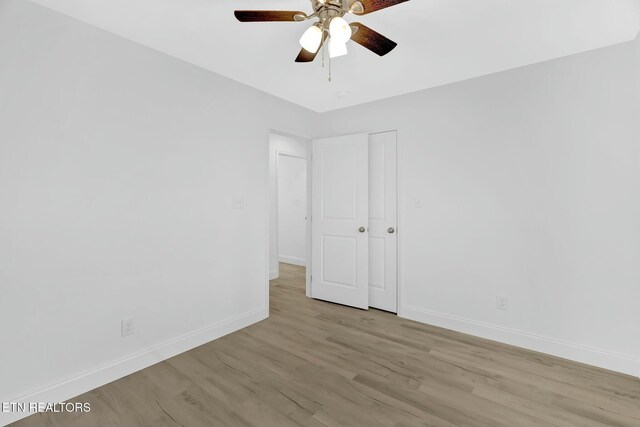 spare room featuring ceiling fan and light wood-type flooring