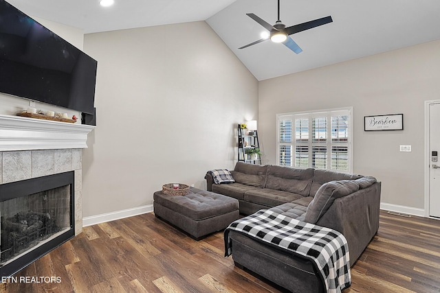 living room featuring a fireplace, high vaulted ceiling, dark hardwood / wood-style floors, and ceiling fan