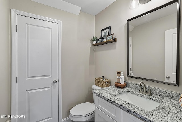 bathroom featuring vanity and toilet