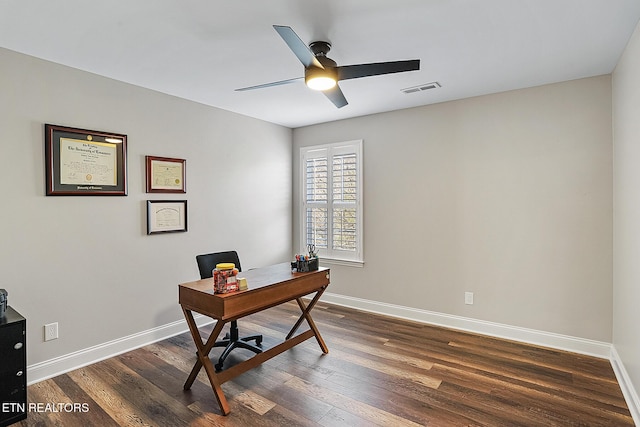 office with dark hardwood / wood-style floors and ceiling fan