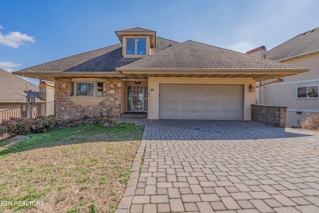 view of front of house with a garage and a front yard