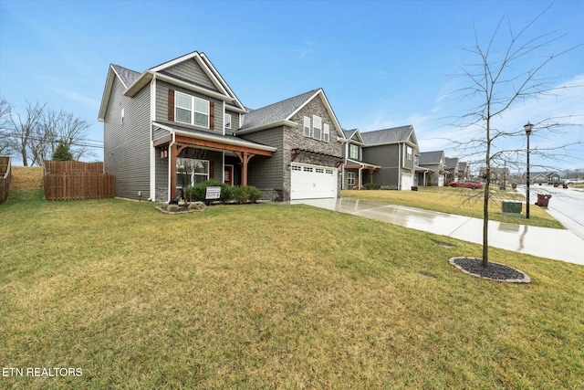 view of front of house with a garage, a front yard, and covered porch