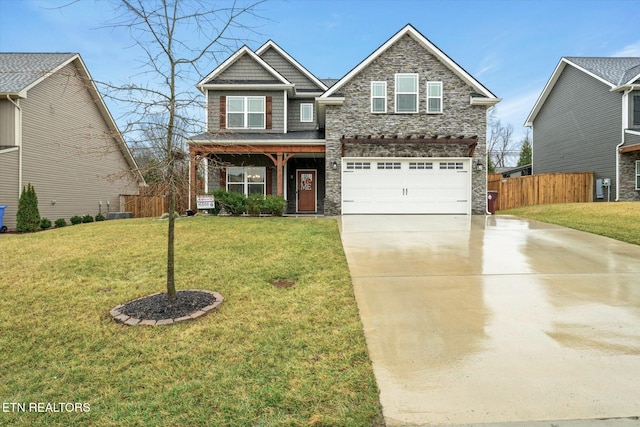 craftsman inspired home featuring a garage and a front lawn