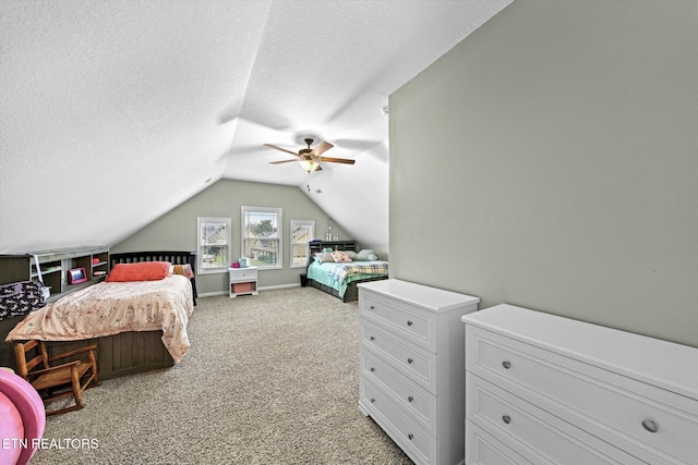 bedroom featuring ceiling fan, light colored carpet, vaulted ceiling, and a textured ceiling