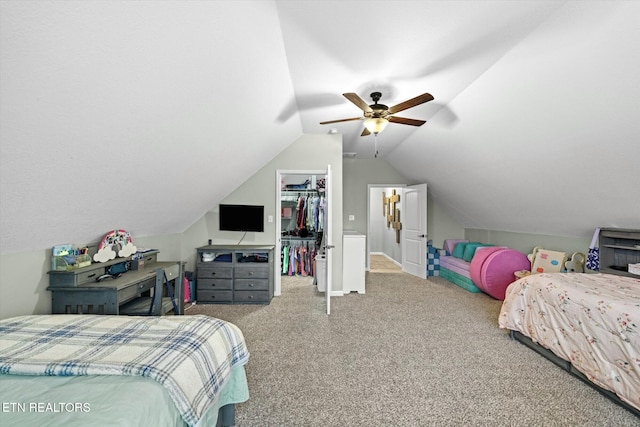 bedroom featuring a walk in closet, vaulted ceiling, carpet floors, a closet, and ceiling fan