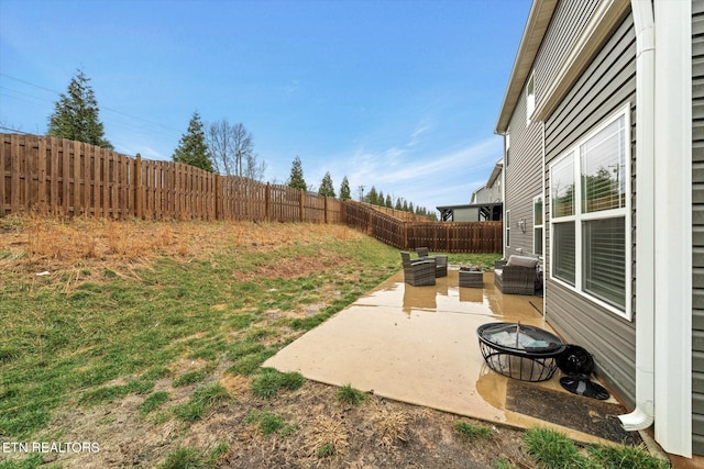 view of yard featuring an outdoor living space with a fire pit and a patio area