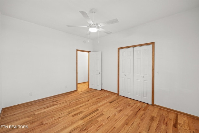 unfurnished bedroom with ceiling fan, a closet, and light wood-type flooring