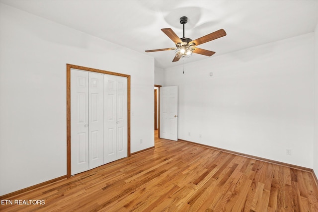 unfurnished bedroom with light hardwood / wood-style flooring, a closet, and ceiling fan